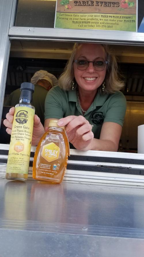 Green Gate Olive Grove co-owner Sally Gist shows some of the products she and husband David have created and/or offer from locally sourced farms, like this vinegar featuring honey from Smiley B Farms in Graceville.